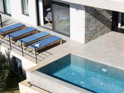 a swimming pool in the backyard of a house at Villa Oniriko in Marioú