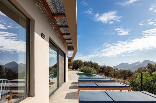 a row of benches on the balcony of a house at Villa Oniriko in Marioú