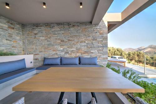 a wooden table on the patio of a house at Villa Oniriko in Marioú