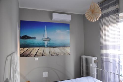 a painting of a sail boat on the water at Casa Marzi in Pesaro