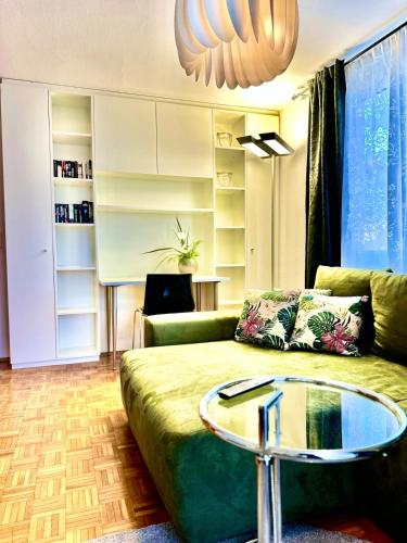 a living room with a couch and a glass table at Boutique Appartement mit Balkon in Lauterach