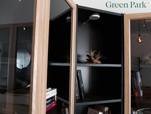 a wooden book shelf with a green pantry at Green Park Rooms in San Donato Milanese
