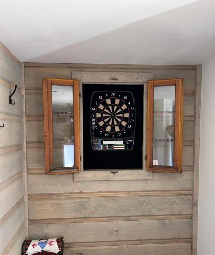 a dart board in a room with two windows at Chalupa Daniel in Ždiar