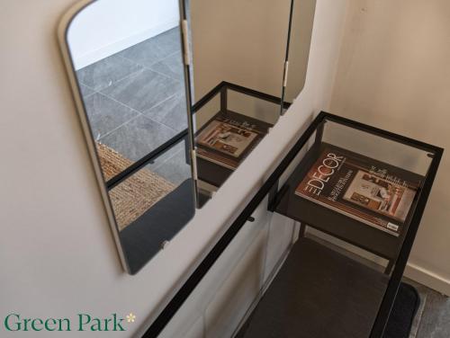 a mirror on the side of a stairway at Green Park Rooms in San Donato Milanese