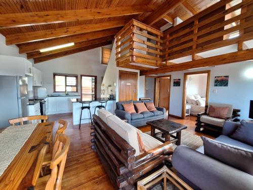 a living room with a couch and a table at Nine Waves Beach House in Port Alfred