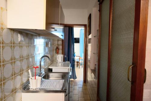 a kitchen with a sink and a counter top at Casa Nenetta in La Maddalena