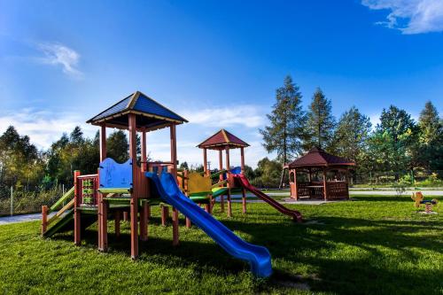 a playground with slides and gazebos in a park at Trzy Korony in Głogów Małopolski