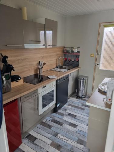 a kitchen with a sink and a counter top at Gite Baie de Somme in Cayeux-sur-Mer