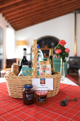 a basket of food and wine on a table at Nanna's Country Home in Feteira Grande