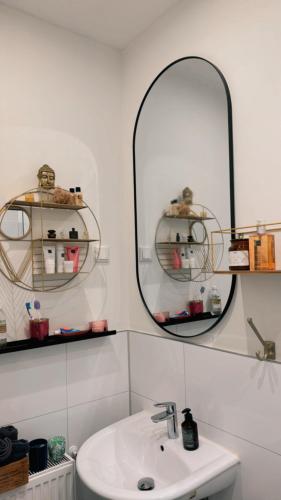 a bathroom with a sink and a mirror at Luxury Stay Düsseldorf Altstadt Moments in Düsseldorf