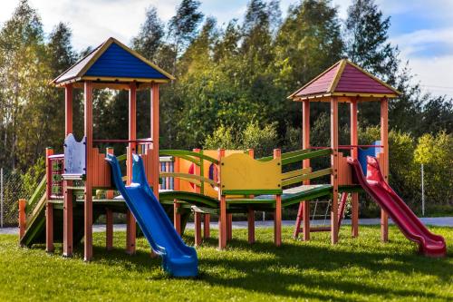 a group of playground equipment in the grass at Trzy Korony in Głogów Małopolski