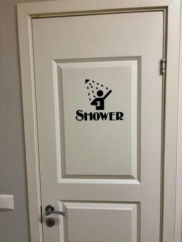 a door with a sign that says shower on it at Angelas Fjord Suite in Stamsund