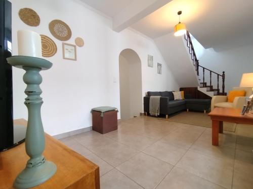 a living room with a couch and a table at Casa do Cruzeiro in Lagoa