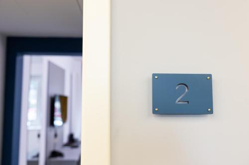 a sign on the side of a door with the number two at Johann Strauss Hotel in Bucharest