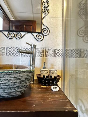 a bathroom with a sink and a mirror at Nergis Hotel in Karaburun