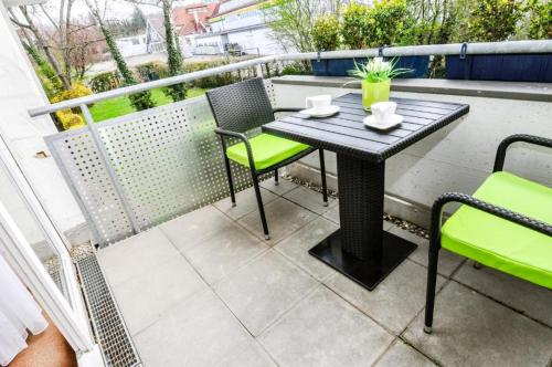 a table and chairs on a balcony with a table at Hotel Garni Superior in Metzingen