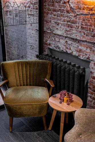 a chair and a table in front of a radiator at Mr. Jordaan in Amsterdam