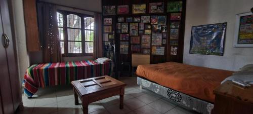 a bedroom with a bed and a table in it at Suite Artistica in Mendoza