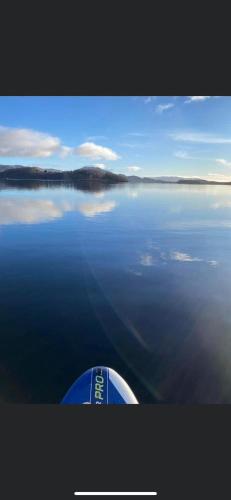 a boat in the middle of a large body of water at Lochside-1Bed-Pet Friendly-Amazing views in Alexandria