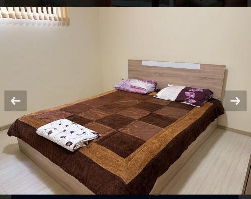 a bed with two pillows on it in a room at Албена хилс in Rogachevo