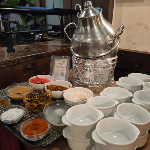 a counter with bowls and a tea kettle on it at Pearl Hotel, Maadi in Cairo