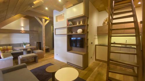 a room with a staircase and a living room at Apartmán v Beskydech in Dolní Lomná