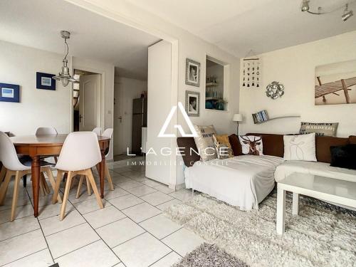 un salon avec un canapé et une table dans l'établissement Maison 3 chambres avec terrasse, animaux admis, parking - FR-1-236-132, à Merlimont