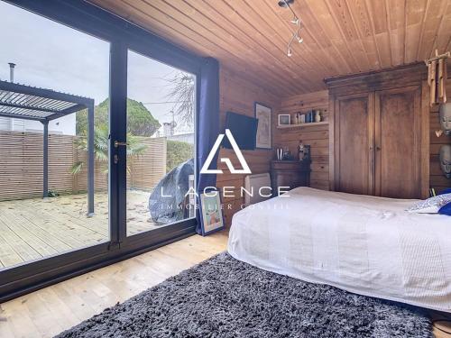 une chambre avec un lit et une grande fenêtre dans l'établissement Maison 3 chambres avec terrasse, animaux admis, parking - FR-1-236-132, à Merlimont