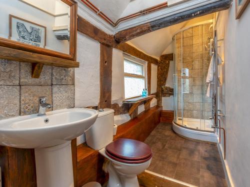 a bathroom with a sink and a toilet and a shower at Pass the Keys Stay in the Original Home of the Gingerbread Man! in Market Drayton