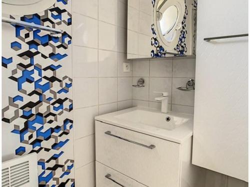 a white bathroom with a sink and a mirror at Charmant T2 à Stella-plage, proche mer, tout confort - FR-1-236-147 in Cucq