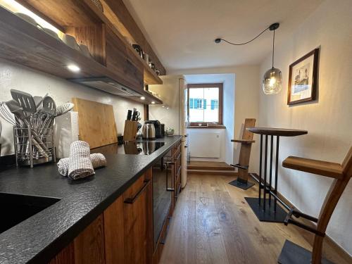 a kitchen with a counter and a table in it at DAS MANTINGER- Style - Blick- Tradition in Kitzbühel