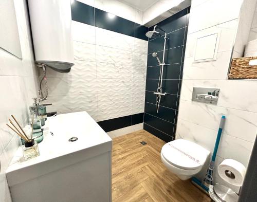 a bathroom with a white sink and a toilet at "Петър 27" Апартамент До Плажа С Паркинг "Peter 27" Top Center And Private Parking in Burgas City