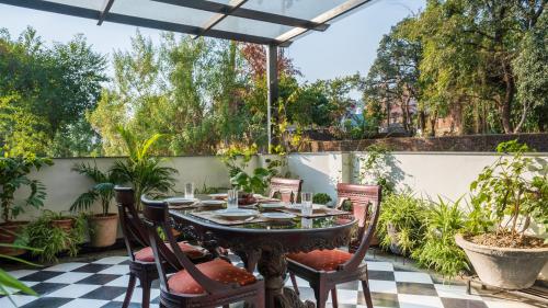 an outdoor patio with a table and chairs at Chakk 109 Mussoorie Foothills, Dehradun in Dehradun