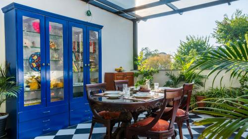 an outdoor dining room with a table and chairs at Chakk 109 Mussoorie Foothills, Dehradun in Dehradun
