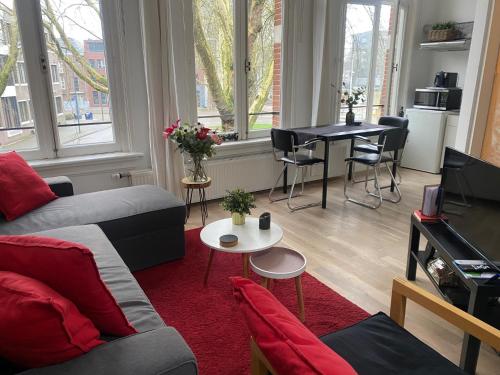 a living room with a couch and a table at De Kardinaal in Den Bosch