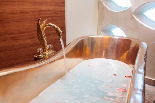 a bath tub filled with water in a bathroom at Vitalia Seehotel in Bad Segeberg