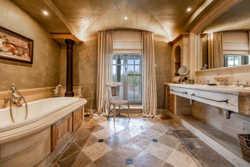 a bathroom with a tub and a sink at LeSable luxury vacation home in Kluisbergen