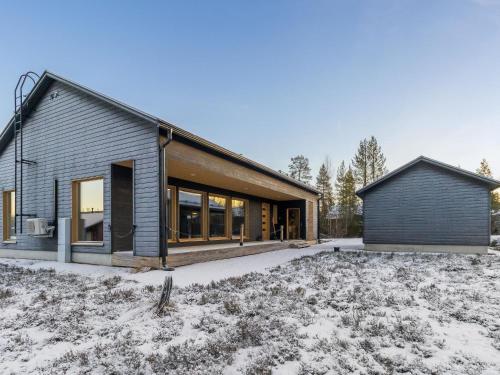 a house in the snow with a garage at Holiday Home Villa plywood by Interhome in Syöte