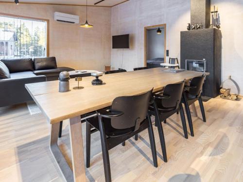 a living room with a large wooden table and chairs at Holiday Home Villa plywood by Interhome in Syöte