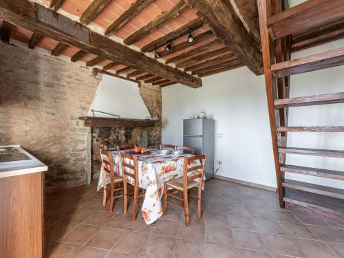 a kitchen and dining room with a table and chairs at Holiday Home Fuoco by Interhome in Zancona