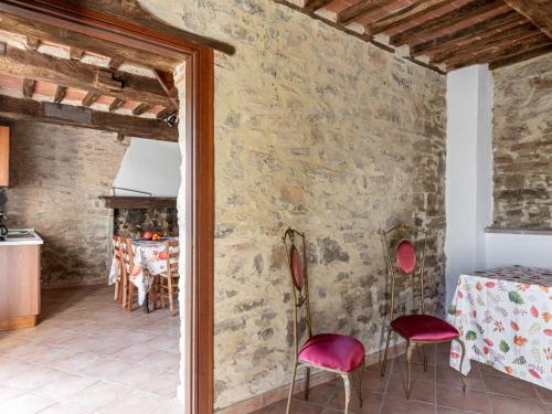 a kitchen and dining room with a stone wall at Holiday Home Fuoco by Interhome in Zancona