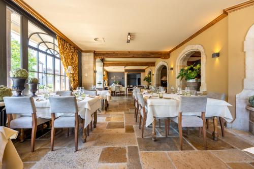 a restaurant with white tables and chairs and windows at LeSable luxury vacation home in Kluisbergen