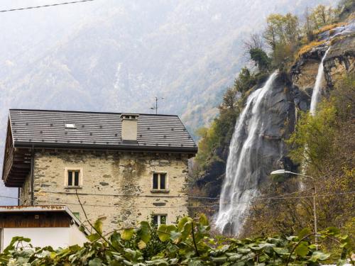 a house in front of a waterfall at Holiday Home Borgonuovo Waterfall's House by Interhome in Piuro