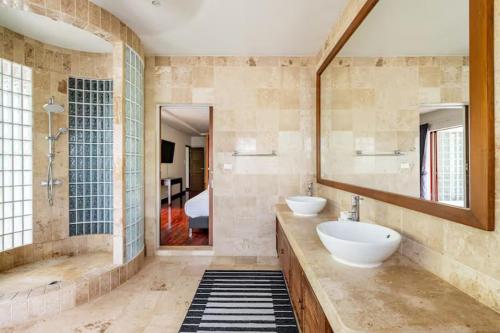 a large bathroom with two sinks and a mirror at Surin villa by Pattara in Ban Lum Fuang