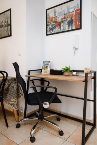a desk with a chair in a room at Sunrise Apartment in Heraklio Town