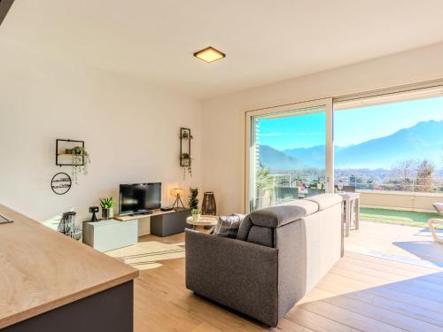 a living room with a couch and a large window at Apartment Vigna Luisa by Interhome in Gera Lario