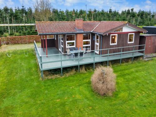 a small house with a large green yard at Holiday Home Slava - 75m from the sea by Interhome in Hesselager