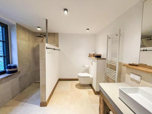 a bathroom with a toilet and a sink at Chalet Glamping in der Orangerie by Interhome in Heyda