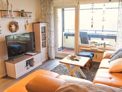 a living room with a couch and a tv at Apartment Ostsee-Residenz by Interhome in Damp