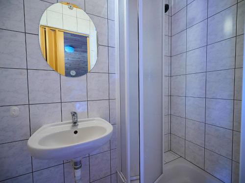a white bathroom with a sink and a mirror at Holiday Home Burger by Interhome in Harrachov